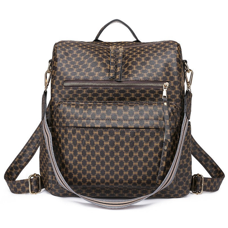 brown bat pattern womens backpack with repeated geometric motif front zippers and patterned carry strap
