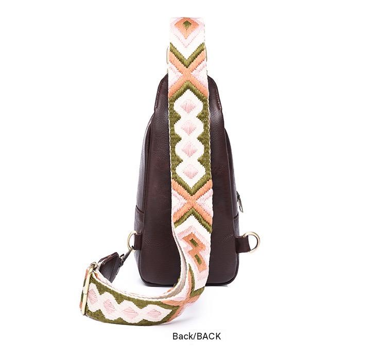 rear view of brown compact crossbody sling bag with smooth pu back panel and adjustable patterned shoulder strap