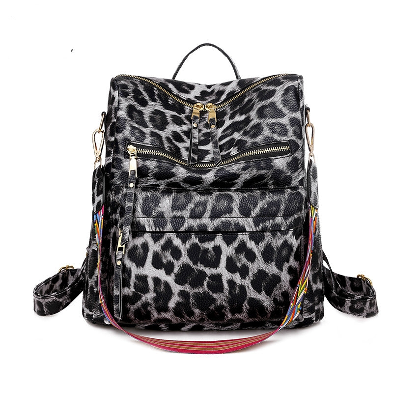 gray leopard print womens backpack with front zipper storage top carry handle and patterned shoulder strap