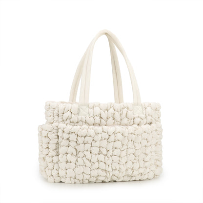 beige soft textured quilted diaper tote with large storage area and reinforced carry handles