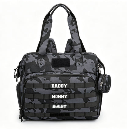 black camouflage tactical diaper bag tote with front webbing rows patch area top handles and round side zipper pouch