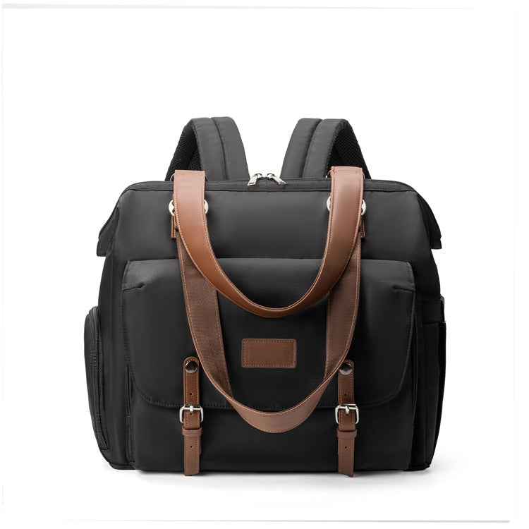 black convertible diaper bag tote backpack with brown trim dual top handles front flap pocket and side compartments