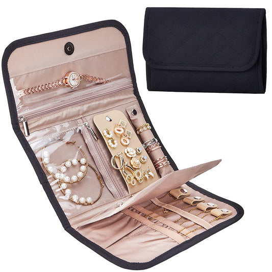 black foldable travel jewelry organizer shown closed and open with clear PVC zipper pockets earring holder ring straps and pink lining