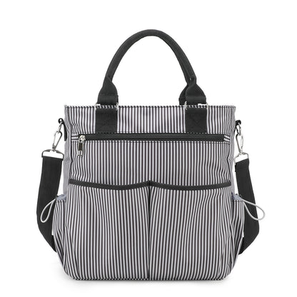 black and white striped polyester diaper bag tote with black carry handles detachable shoulder strap and front organizer pockets
