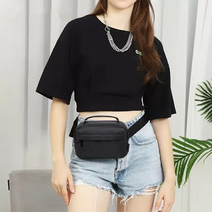 woman wearing a compact black waist bag with top carry handle and adjustable strap around the waist