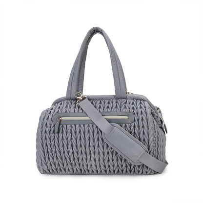 blue textured quilted travel diaper tote with top handles and detachable shoulder strap