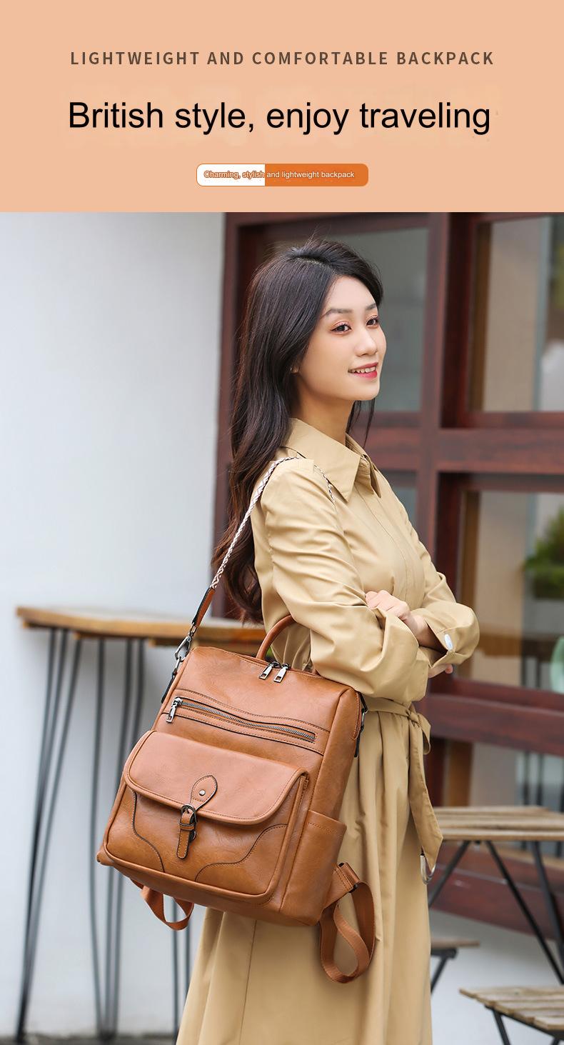 woman carrying brown vintage-style ladies travel backpack with top handles front flap pocket and adjustable shoulder straps