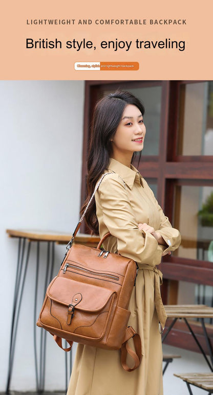 woman carrying brown vintage-style ladies travel backpack with top handles front flap pocket and adjustable shoulder straps