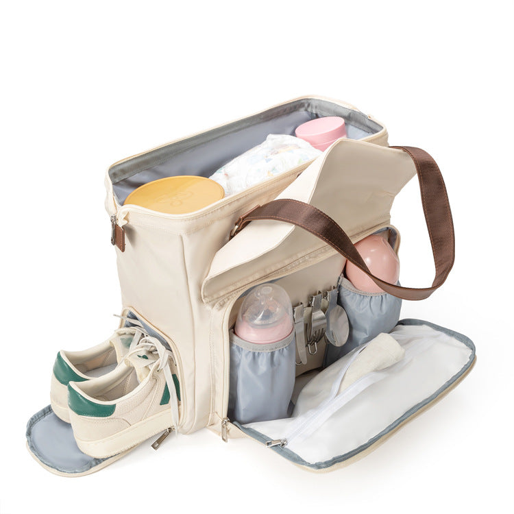 open convertible diaper bag showing bottle organizer elastic holders fold-down front section and separate side shoe compartment