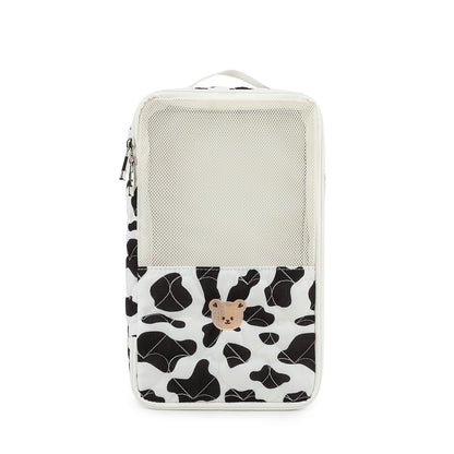 black and white cow print diaper bag organizer pouch with cream mesh section top carry handle and bear patch