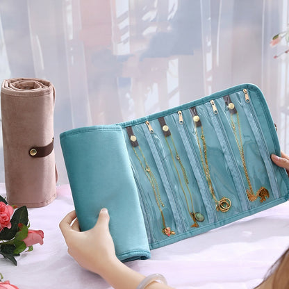custom roll up jewelry organizer in light blue with clear zippered compartments and powder brown rolled jewelry case