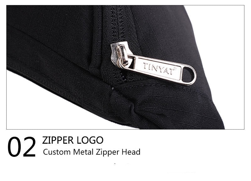 close up of silver metal zipper pull with engraved branding on black custom waist bag