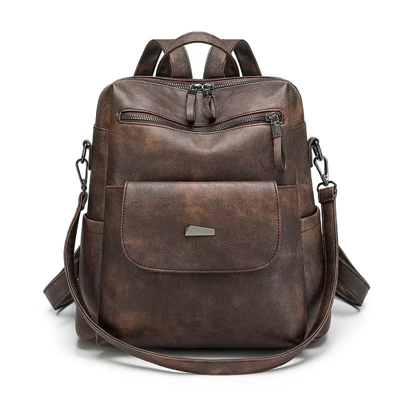 dark brown pu backpack with curved front zipper magnetic flap compartment and side pockets