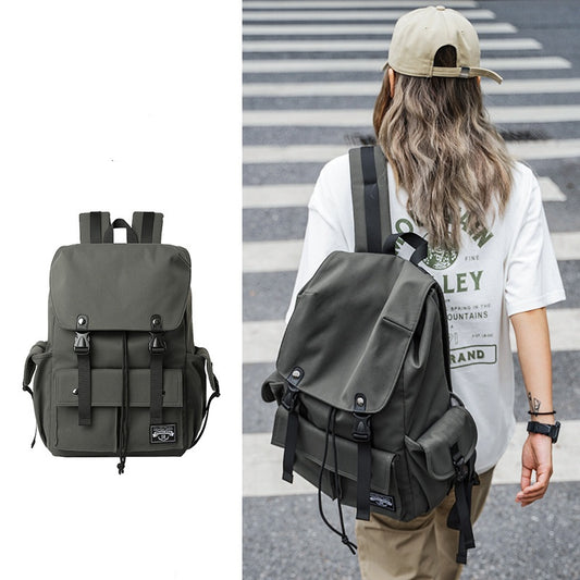 dark green custom drawstring laptop backpack with flap closure and front storage worn by woman