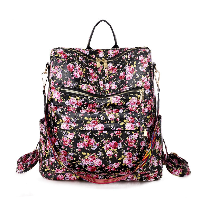 black floral print womens backpack with pink flowers multiple zipper pockets and backpack straps
