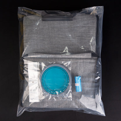 folded pet carrier backpack package with collapsible bowl waste bags and packed travel accessories