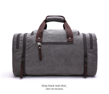 gray canvas travel duffel back view with rear zipper pocket and reinforced handles