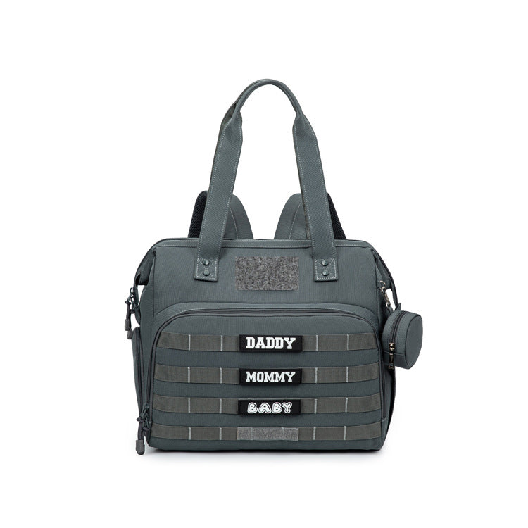 gray convertible diaper bag tote with backpack strap attachments front webbing storage pocket and top handles