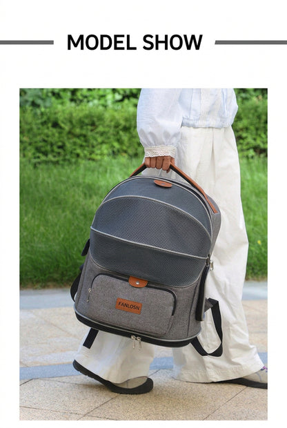 woman carrying gray pet travel backpack by its orange top handle outdoors