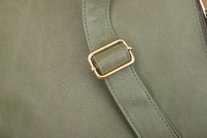 close up of adjustable green pu backpack shoulder strap with gold tone rectangular metal buckle and stitched edges