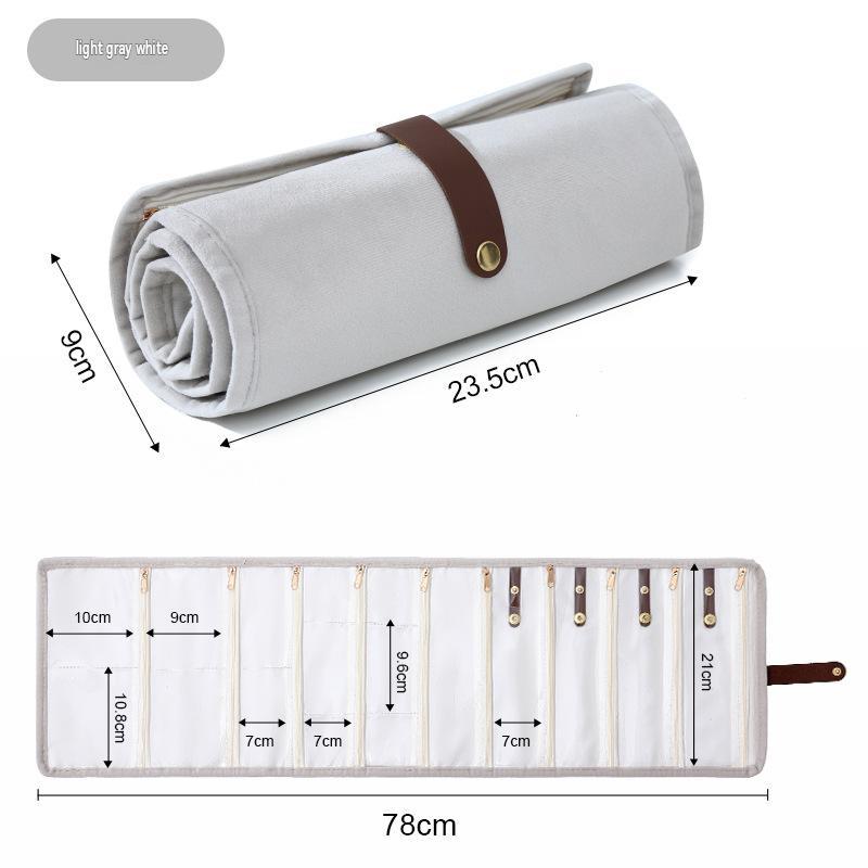 greige velvet jewelry organizer shown rolled and fully open with clear zipper compartments and snap button holders