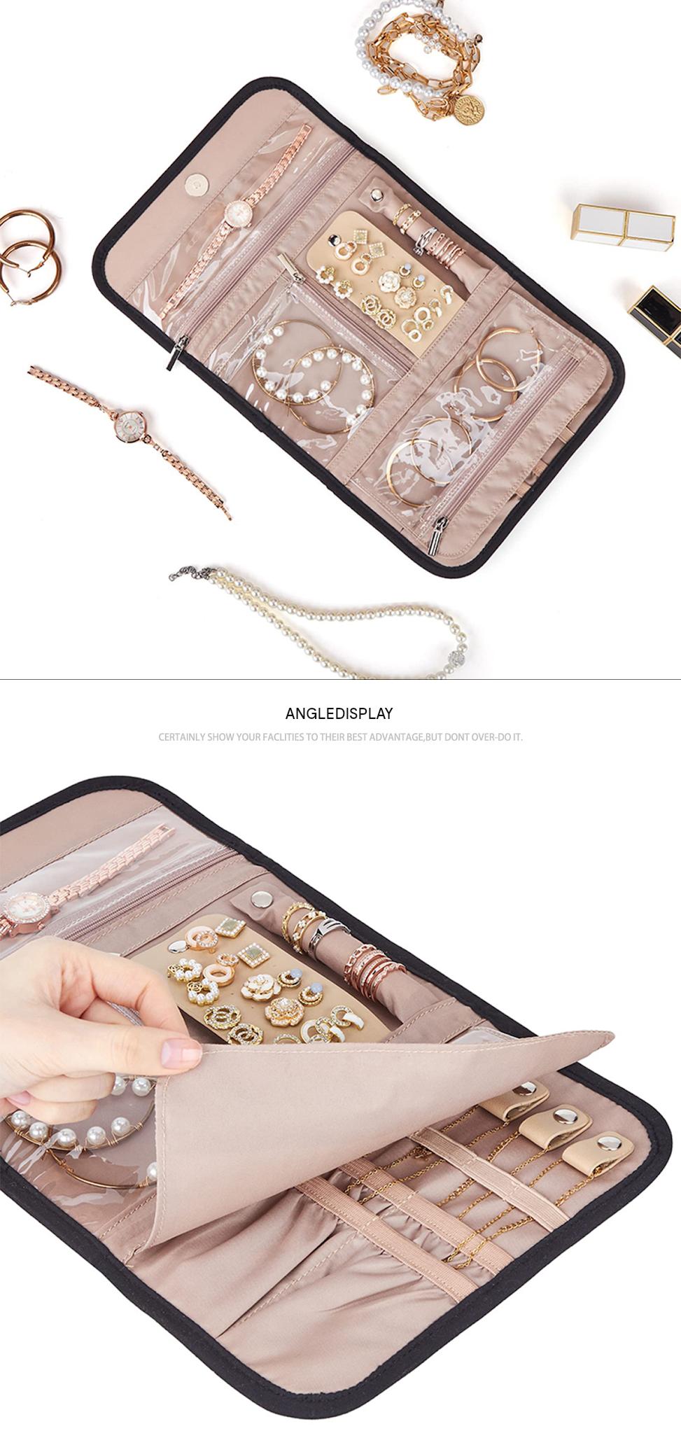 open travel jewelry organizer surrounded by jewelry with a hand lifting the fold-out divider to reveal ring and accessory straps