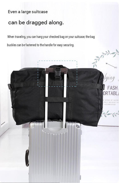 large travel bag secured to a rolling suitcase handle with rear webbing for easier luggage transport