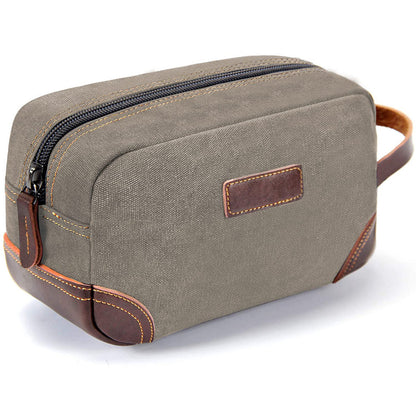 light gray vintage canvas toiletry bag with leather details