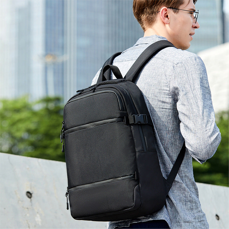 men's commute backpack worn for work with structured black multi-compartment design