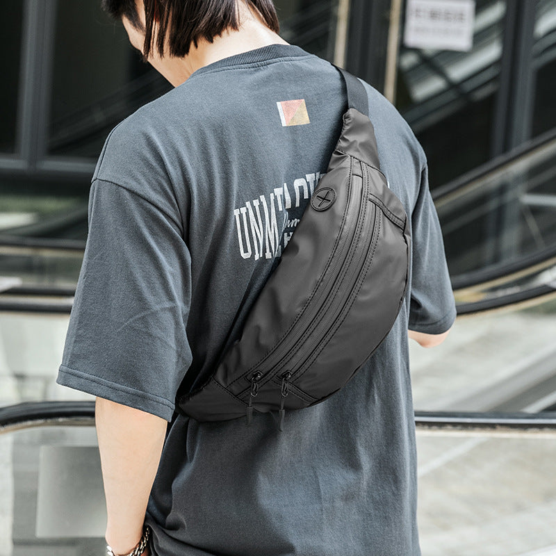 men's multi-pocket waist bag worn across the back with adjustable shoulder strap