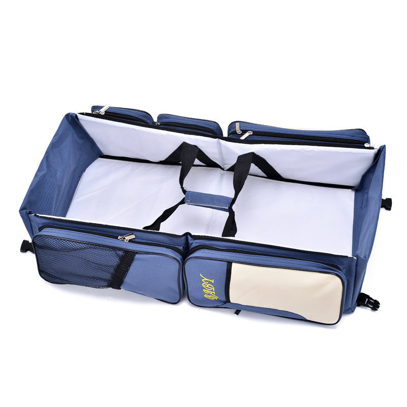 navy blue travel diaper bag with foldable baby bed