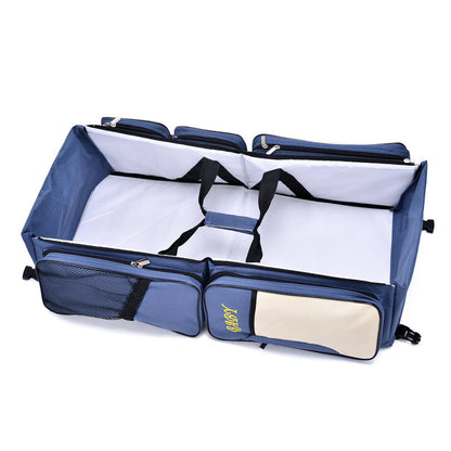 navy blue travel diaper bag with foldable baby bed