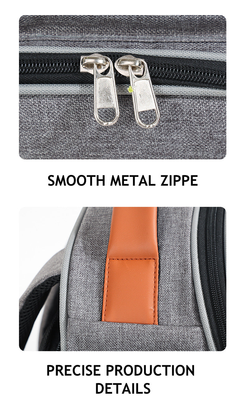 close up of pet carrier backpack showing two metal zipper pulls and orange top handle attachment