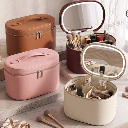 pink and beige makeup cases displayed with open lid mirrors and organized makeup tools