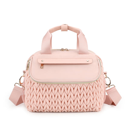pink diaper bag with changing pad textured front panel and shoulder carry strap