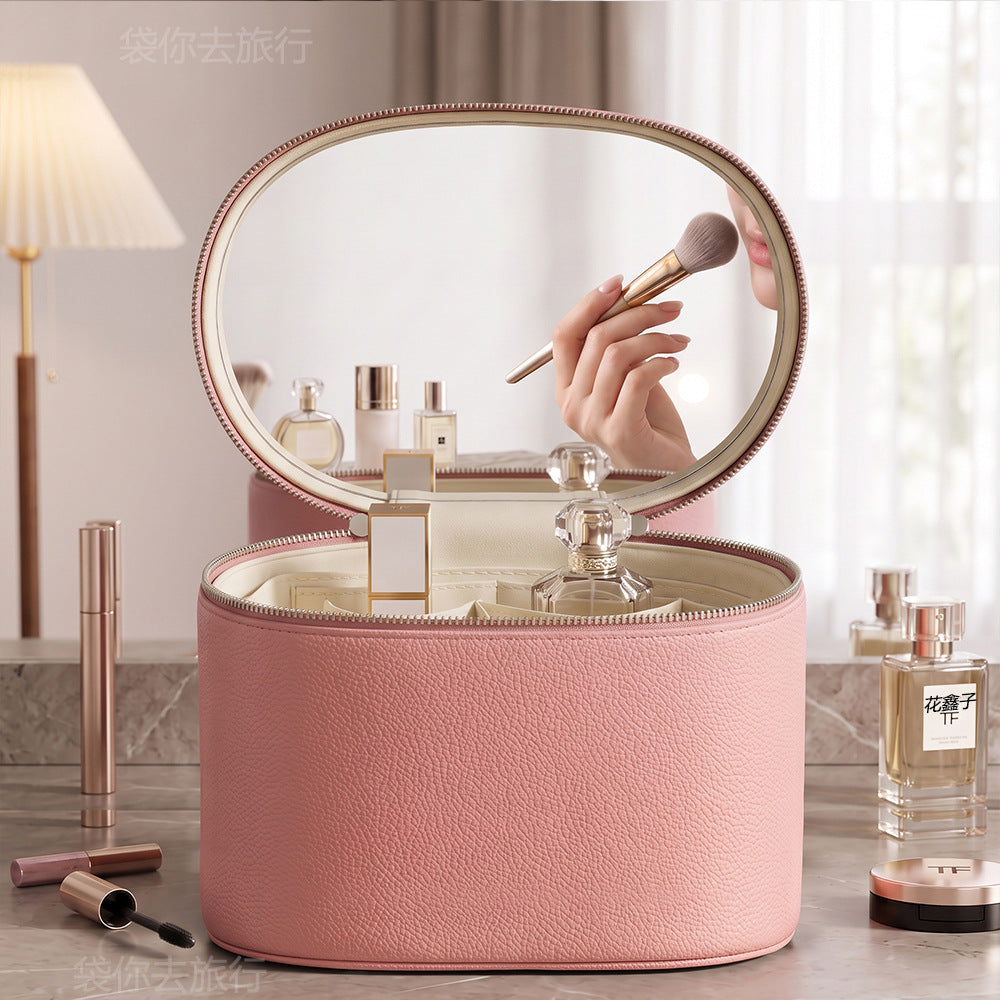 pink makeup organizer case with raised oval mirror lid and rounded zippered body