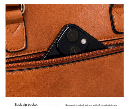 brown pu shoulder bag rear zippered pocket shown holding a smartphone for quick access