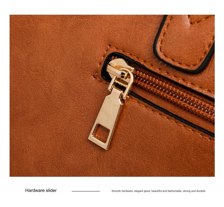 close up of brown pu tote shoulder bag zipper with gold tone metal puller contrasting edge trim and stitching