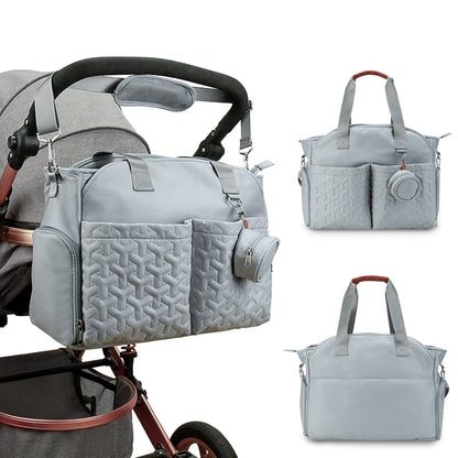 Diaper tote bag attached to baby stroller for travel and daily outings