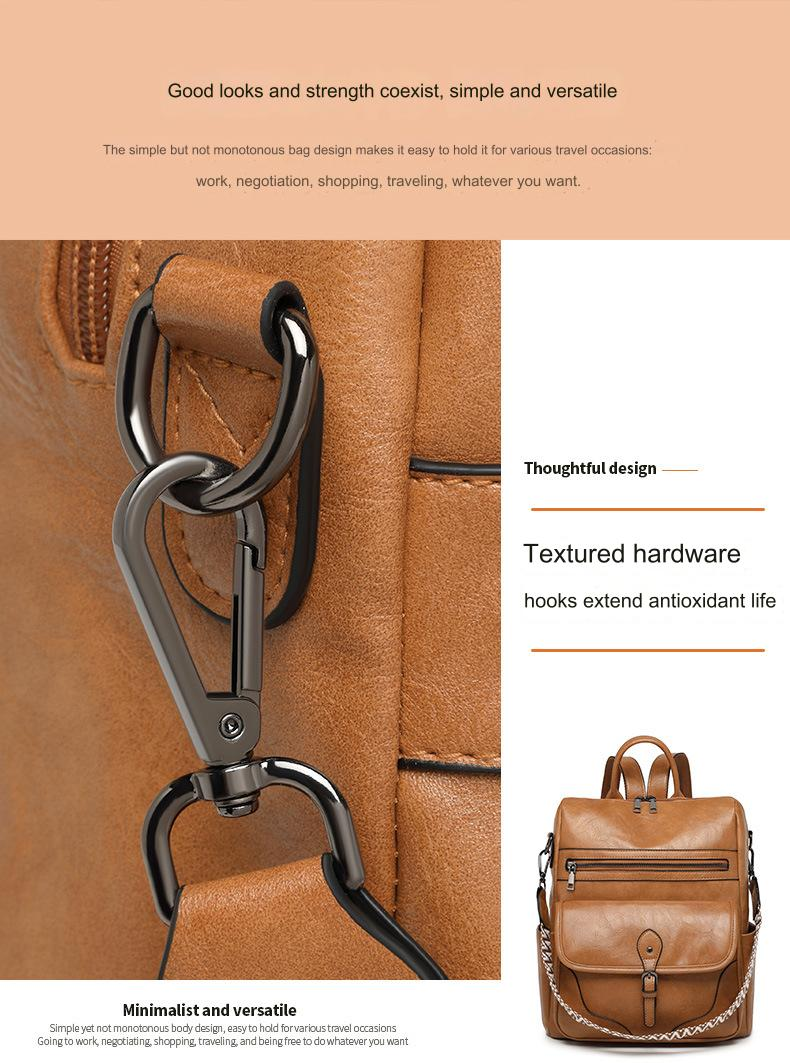 close-up of brown vintage women's backpack shoulder strap attachment with metal-look swivel hook ring and stitched fabric tab
