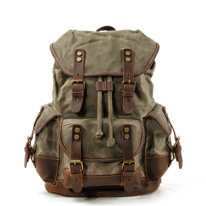 army green canvas backpack with leather accents for outdoor travel and hiking
