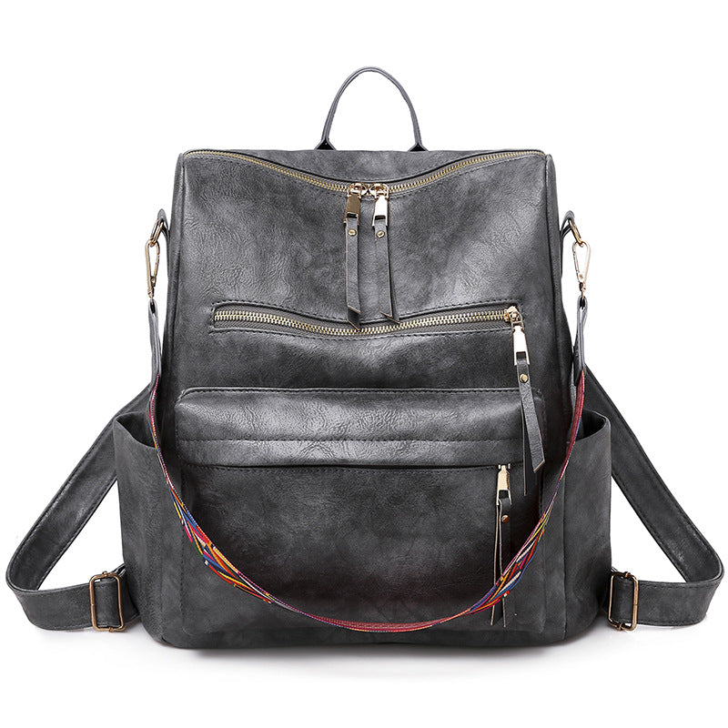 gray pu womens backpack with top double zipper front storage pockets and patterned shoulder strap