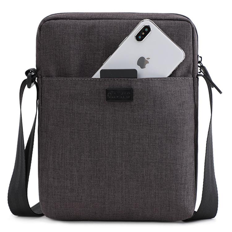 light gray small messenger bag with front phone slip pocket polyester fabric and adjustable black shoulder strap