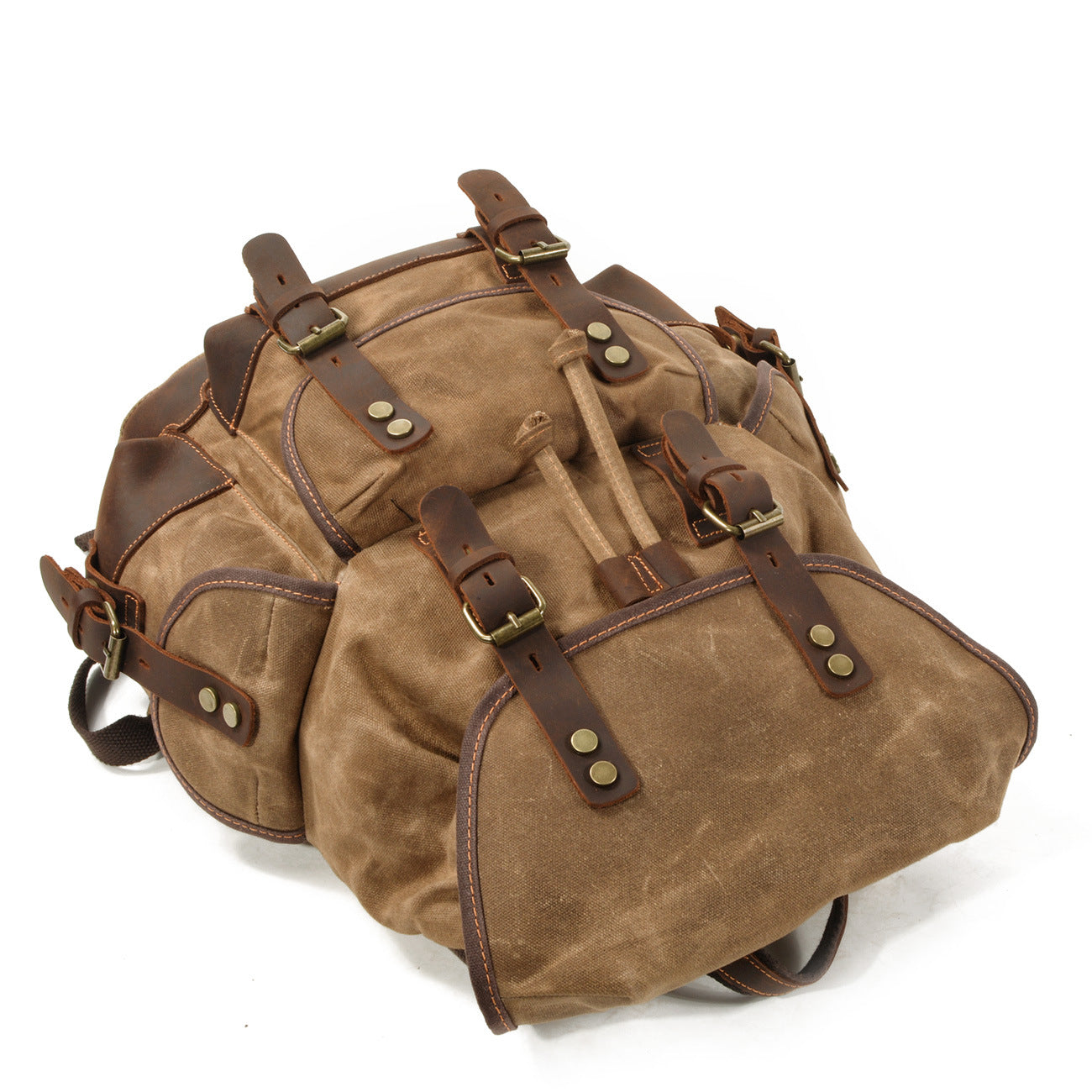 washed canvas backpack side view with leather details and storage pockets